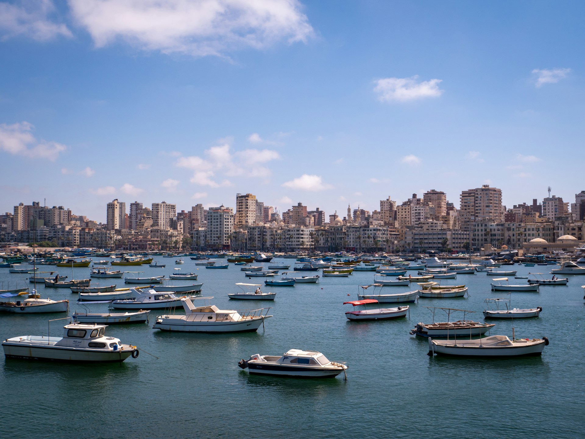 Alexandria Egypt harbor with boats and city skyline along the Mediterranean coast