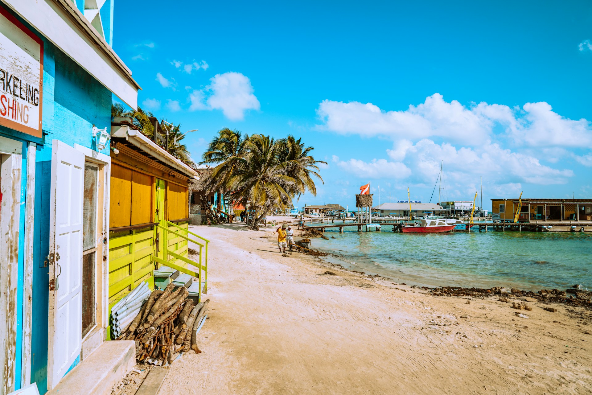Small coastal village in Belize with wooden houses and sandy shoreline