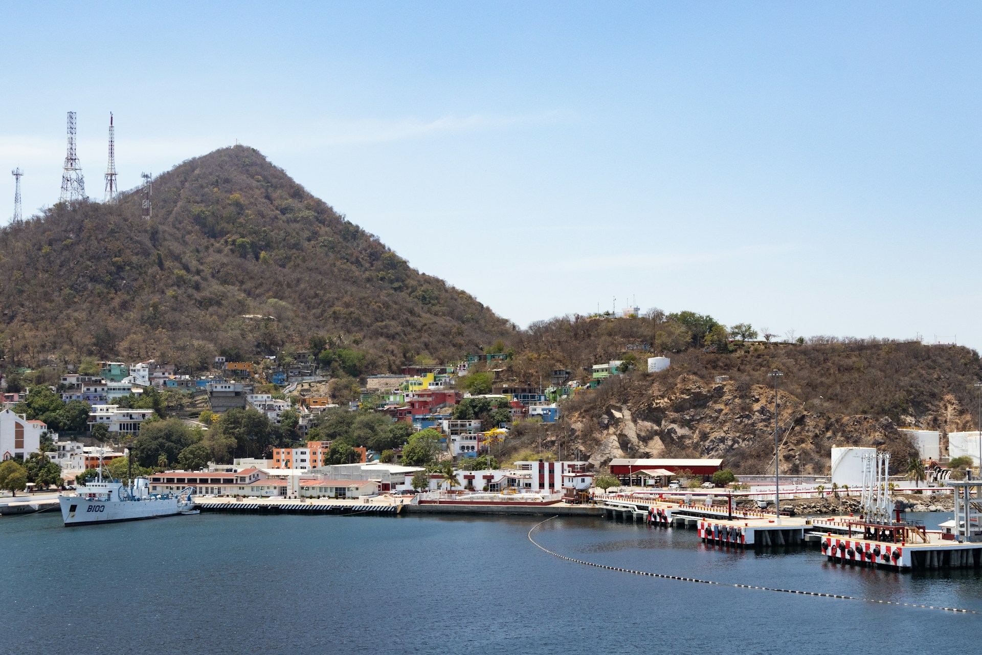 Industrial port area in Manzanillo Mexico with hillside houses and harbor views